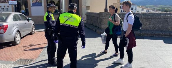 Dos agentes de la Policía Local piden a dos transeúntes que justifiquen su salida. // CharryTV