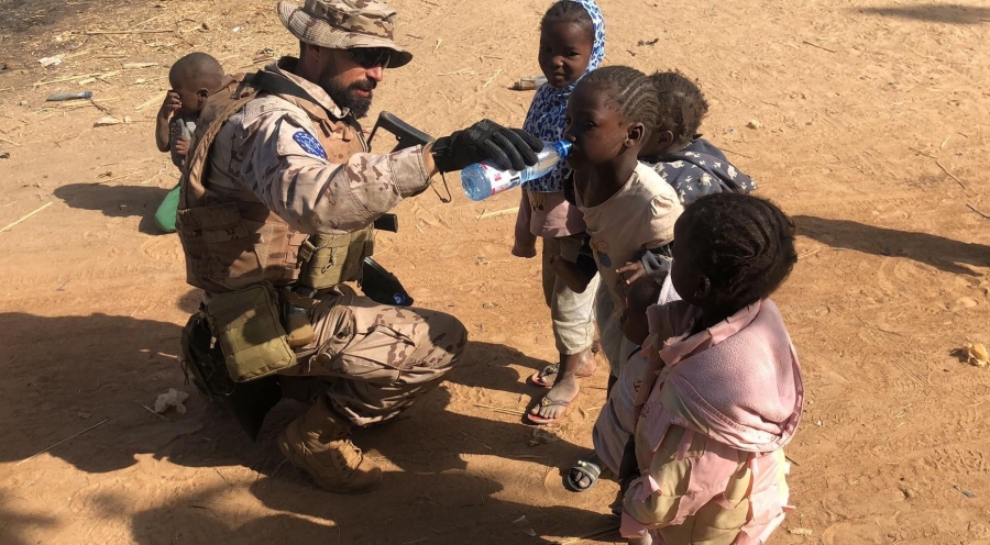 El legionario Mateos, perteneciente a la Xª Bandera, dando de beber a unos niños en un poblado cercano a Koulikoro (Mali)