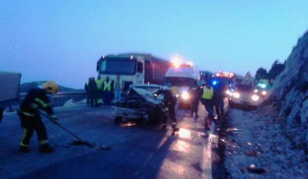 Efectivos del Consorcio Provincial de Bomberos y Guardia Civil realizando labores de limpieza en la calzada.