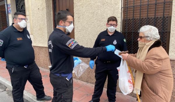 Agentes de policía y miembros de Protección Civil reparten las mascarillas entre la población.