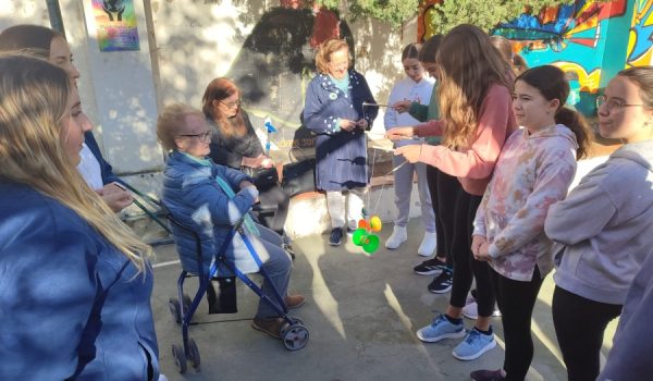 Varias usuarias y alumnas juegan al diábolo en el patio del centro educativo.